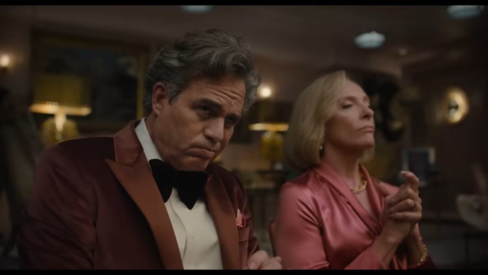 wealthy man and woman wearing suit and bow tie and a pink blouse, respectively.